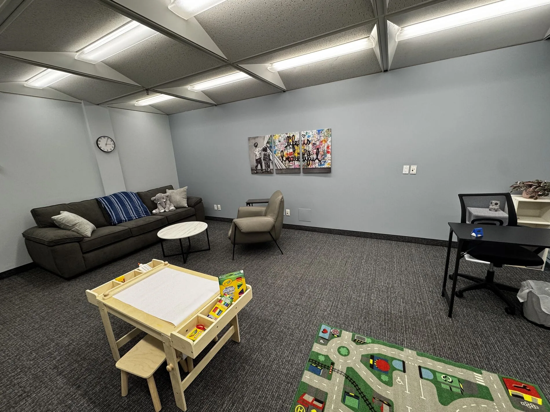 The bright, child-friendly play therapy room at the Flutterby Psychology Calgary office