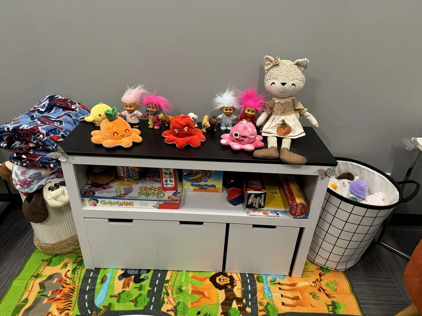 A bright play-and-art table in the Flutterby Psychology family therapy space